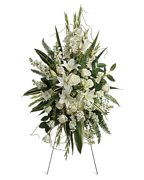 Heartfelt Sympathy Spray - all-white standing floral arrangement with lilies, roses, gladioli and lush greenery on an easel
