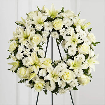Eternal Peace Wreath - all-white standing funeral wreath with lilies, roses, chrysanthemums and ferns on an easel