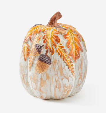 Whitewashed resin pumpkin decoration with autumn leaves and acorns.