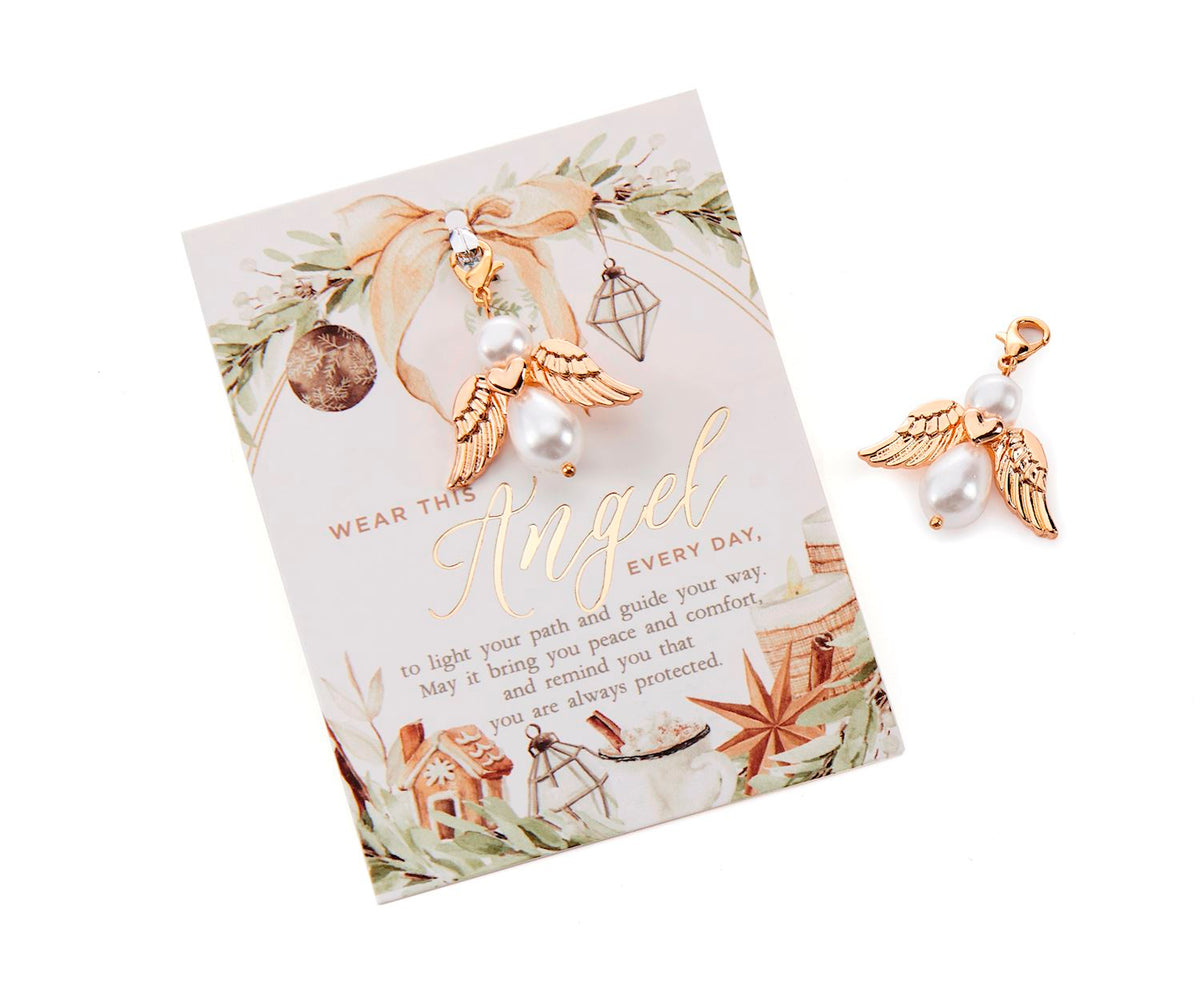 White pearl angel charm with gold-tone detailing and sentiment card.